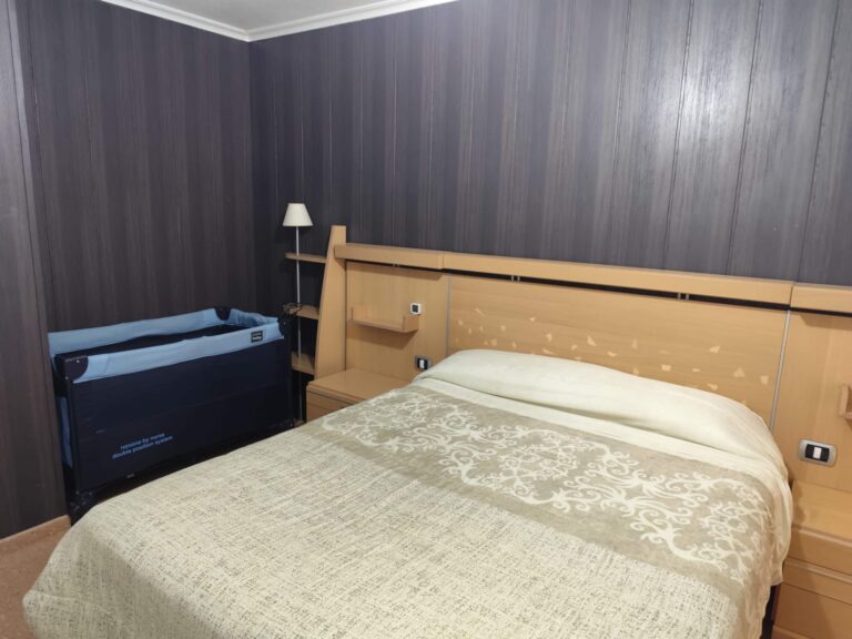 La habitación cuenta con una cama doble y una cuna para bebés